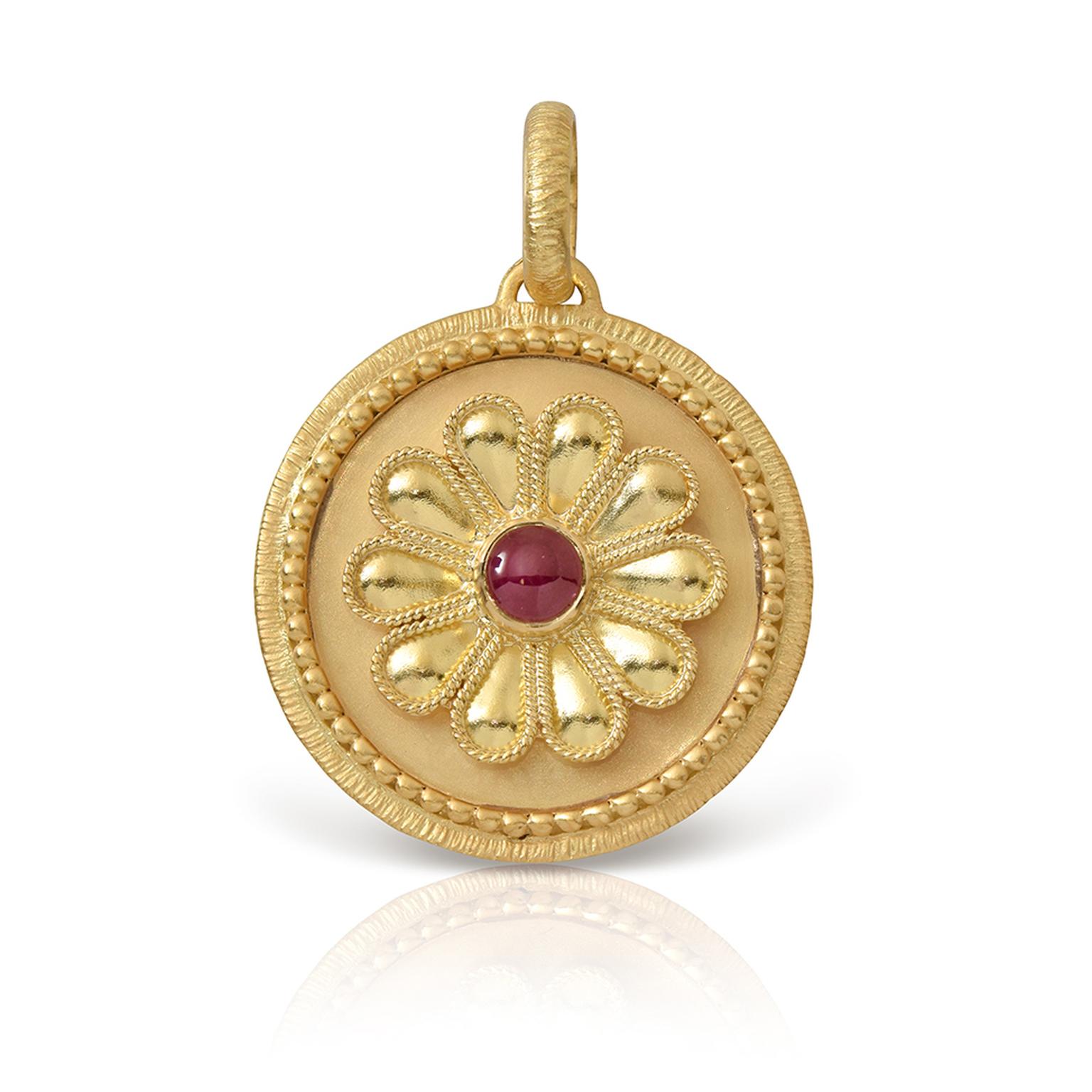 Blossom rosette with garnet bead by Lalaounis